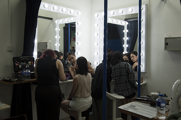 a group of ladies preparing themselves theStudio@SG make up room