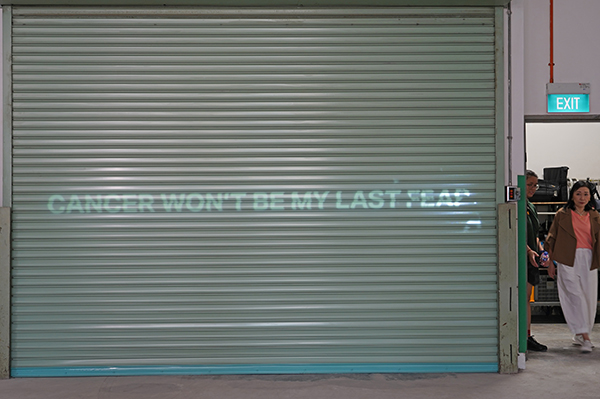 Projection of cancer message against roller shutter 1